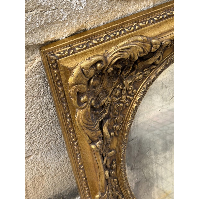 1940s Louis XV style gold leaf wall mirror Frame in gilded and carved wood, decorated with floral motifs and embossed...