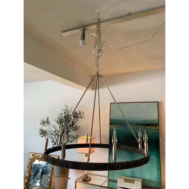 Illuminate your home with the chic elegance of this polished nickel 8-light chandelier, featuring a distinctive lack...