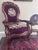 An elegant Victorian Rococo Revival armchair featuring a beautifully carved walnut frame with scrolling foliate details, a...