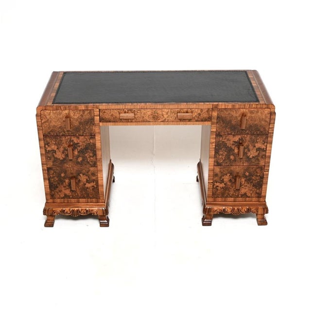An outstanding Art Deco burr walnut leather top desk. This was made in England, it dates from the 1930’s. It is of amazing...
