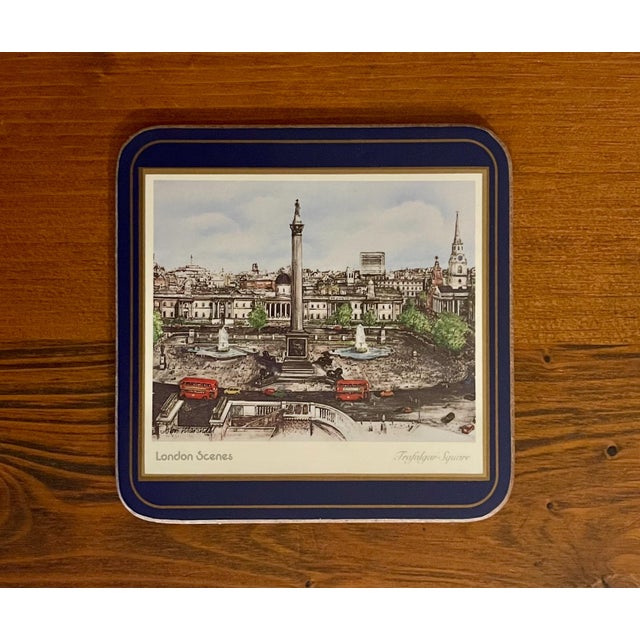 A set of navy framed scenes of famous London landmarks on a cork backing.