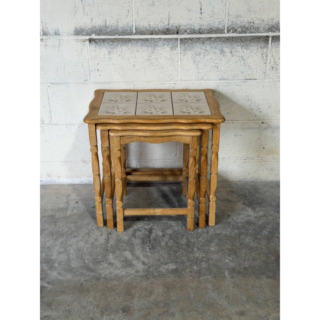 This set of three nesting tables features a convenient space-saving design. The rectangular tops showcase beautiful floral...