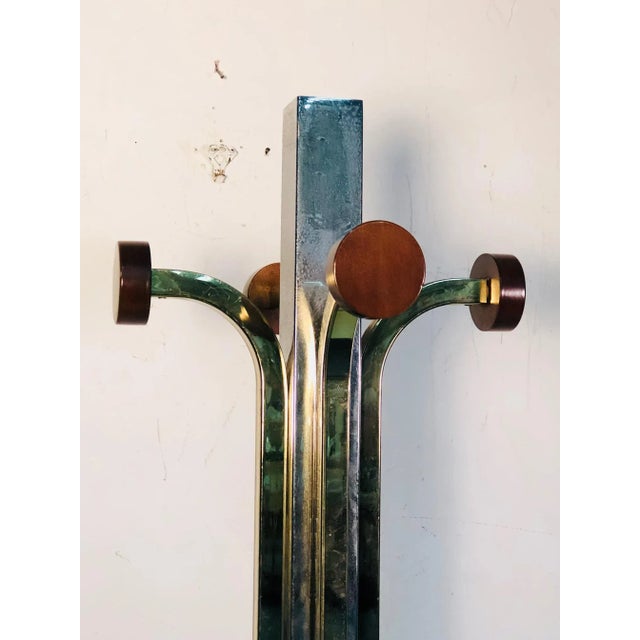 Modern coat rack. Made in Italy of chrome and brass, 1980's. Measures 65" high, 14" by 14" at the base. Some wear...