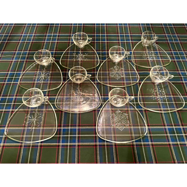 This set of 8 appetizer or dessert plates with matching tea or coffee cups has a unique snowflake design on each plate.