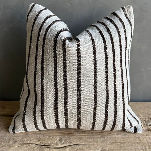 Creamy white hemp rug pillow with stripes. Soft hand, linen blend backing with zipper closure. Spot cleaning is...