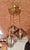 An elegant, modernist pendant light from the 1970s featuring three light sources arranged at different heights. The gold-...