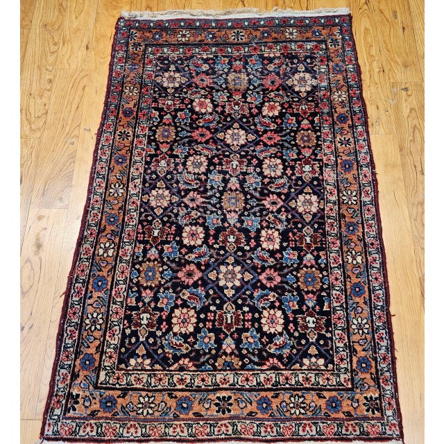 "This vintage Persian Malayer area rug from the early 20th century showcases a highly sought-after allover geometric...