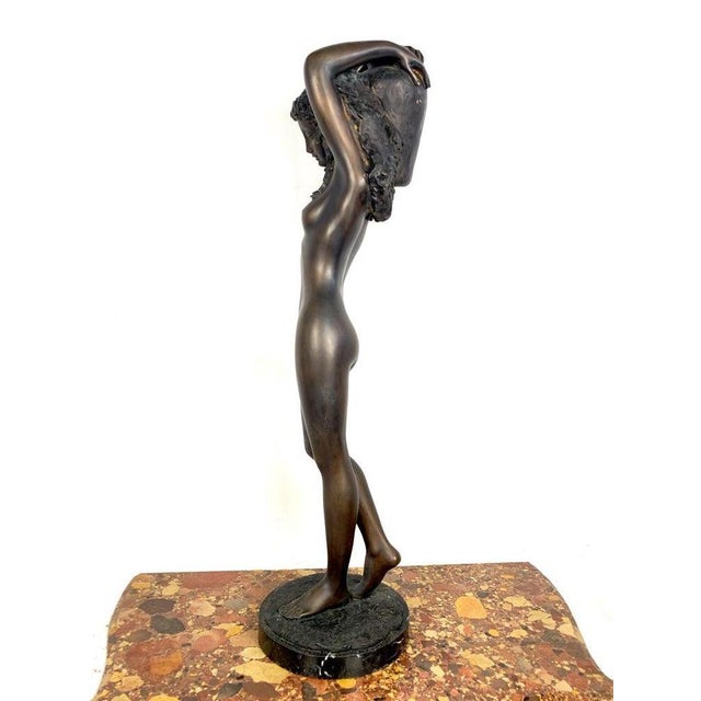 20th century large bronze sculpture of a nude young lady carrying a water urn. H 46 in. X w 13 in. X d 13 in. H 116.84 cm...