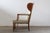 This exceptional vintage wingback armchair, requiring new upholstery, presents a compelling opportunity to restore a...