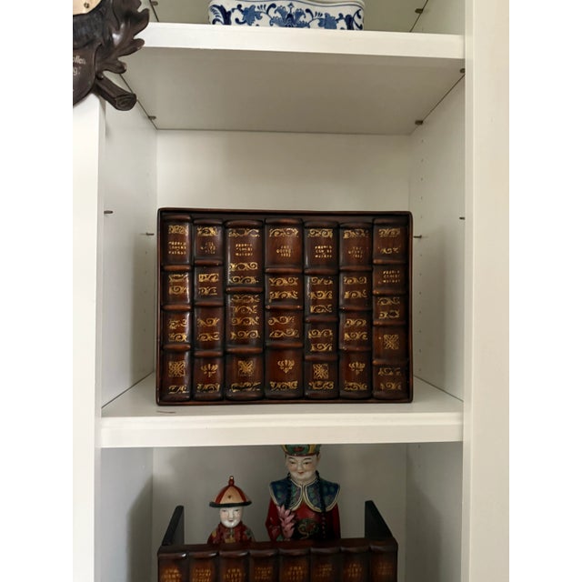 Carved mahogany set of books by Theodore Alexander. Each book has guilt accents. Can be used as a shelf filler, to hide...