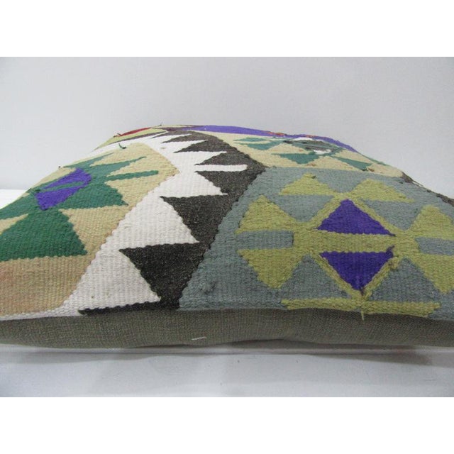 This is a pillow cover made from a vintage kilim rug. The piece was properly washed and ready to use. Pillow inserts not...