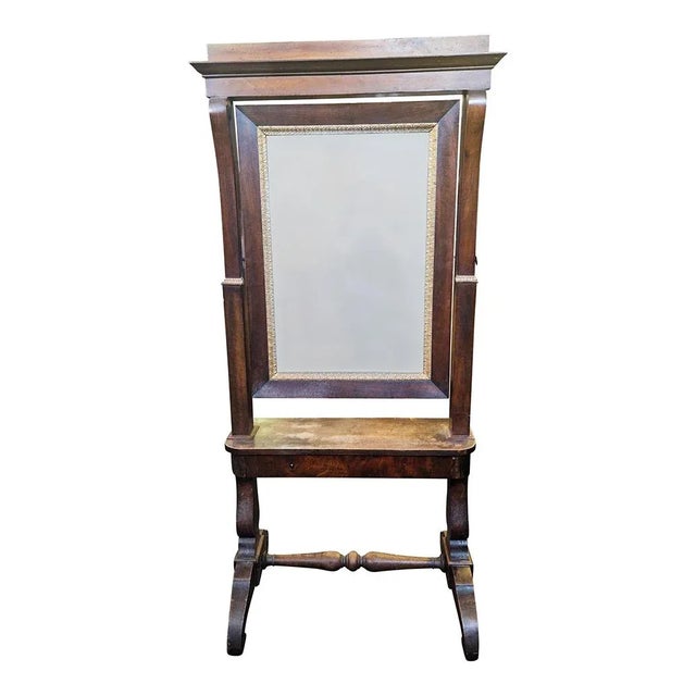 Psyche in solid walnut, early 19th century. The central body with upper entablature and bases ending with wavy feet, has a...