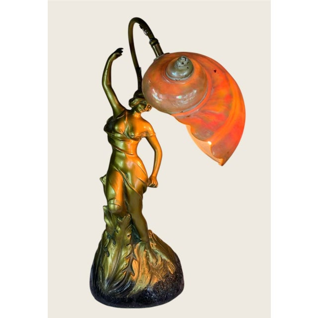 15” high, a spectacular and rare nautilus shell lamp, golden Art Nouveau lady with stem that comes up from the rear which...