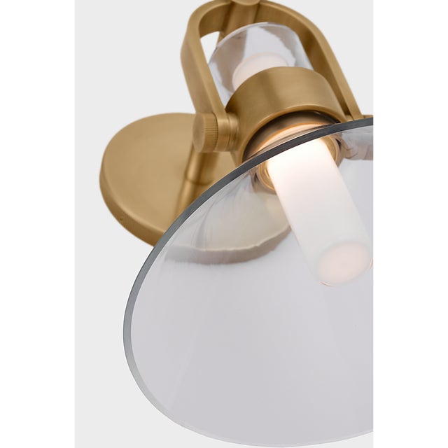 Larkin Small Empire Bracketed Sconce in Hand-Rubbed Antique Brass with Clear Glass Designer: Ian K. Fowler Finish: Hand-...