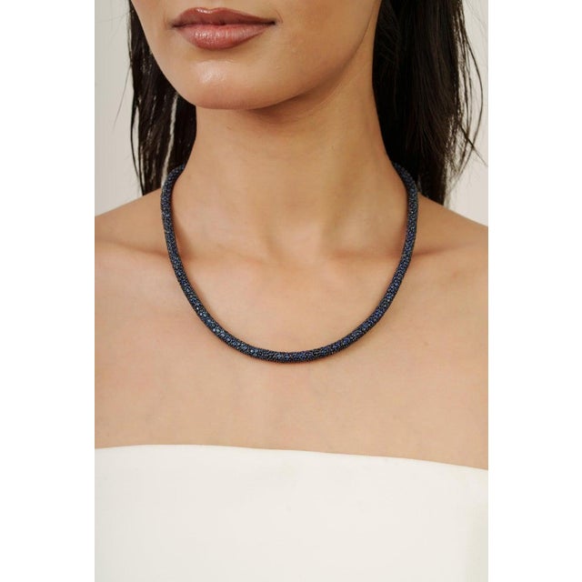 This Crafted in gleaming 925 sterling silver, this stunning pavé necklace showcases natural deep blue sapphires—each...