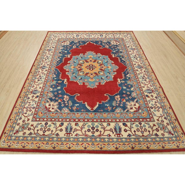 A traditional Caucasian rug hand-knotted with an all-wool pile on a cotton foundation. This oriental rug features a large...