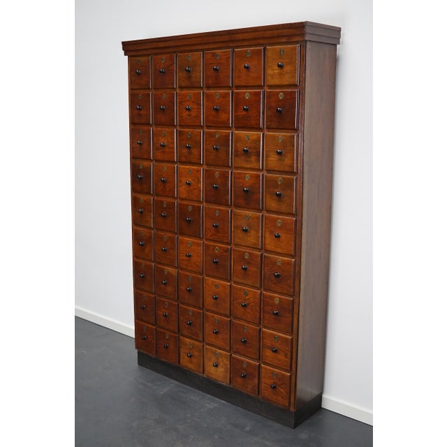 This apothecary cabinet was made circa 1920s in the Netherlands. It features 54 drawers with amazing bakelite knobs and...