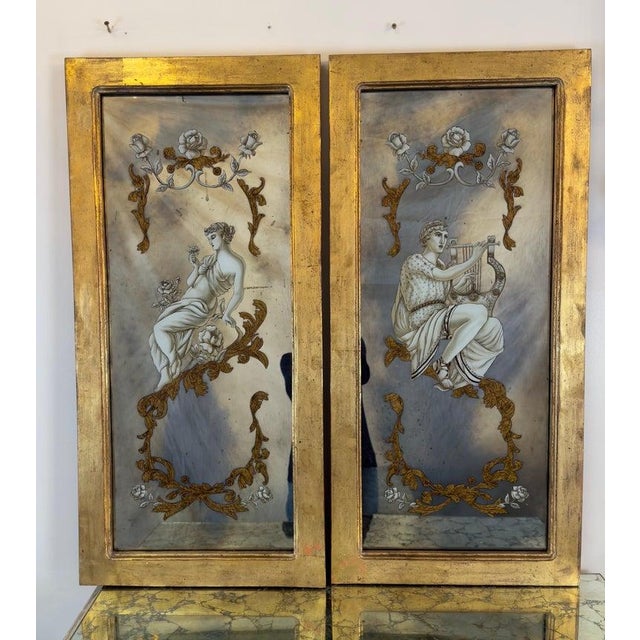 A refined pair of reverse-painted mirrored panels, exquisitely detailed with classical female figures draped in flowing...
