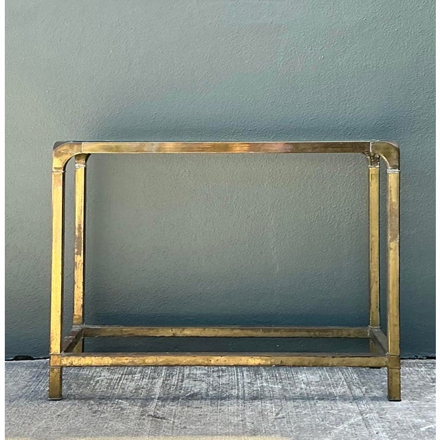 This sophisticated vintage console table, designed in the manner of Mastercraft, captures the glamorous essence of the...
