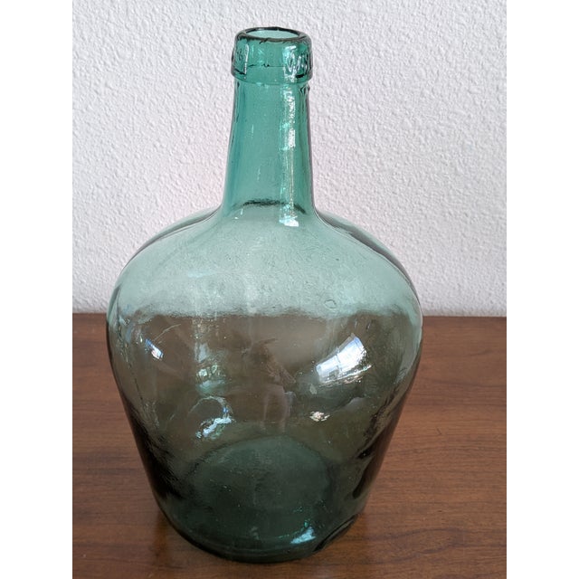 This medium sized, handmade green glass demijohn or carboy is signed Viresa on the spout. Made in the mid-century by...