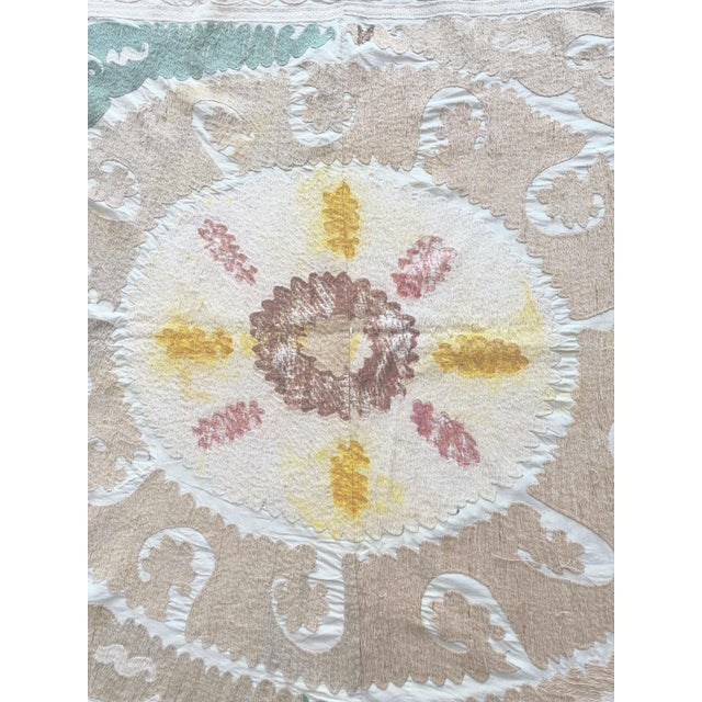 Vintage Suzani from Central Asian, circa 1960s era. There are stains and some wear on this suzani. Dimension; 60'' x 61''...