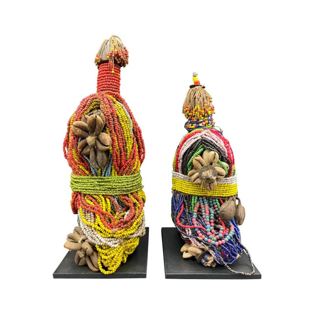 A pair of decorative beaded fertility figures.. Made by men in the Fali culture, they were gifted to their fiancee, who...
