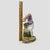 This beautiful porcelain figurine, depicts a young boy performing a handstand against a rustic, leafy backdrop. The piece...