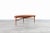 Discover a true icon of Danish modern design with this remarkable coffee table, masterfully crafted by the legendary Finn...