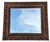 Vintage beveled wall mirror by Carolina Mirror Company featuring an ornate deeply carved frame with a warm gilt finish and...