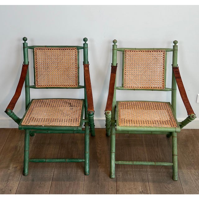 This pair of folding Safari chairs is made of weathered faux bamboo. The back and seat are fluted, and the armrests are...