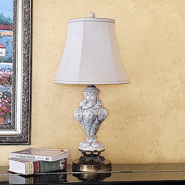 Vintage Capodimonte-style porcelain table lamp featuring an ornate urn form with raised scrollwork, acanthus-inspired...