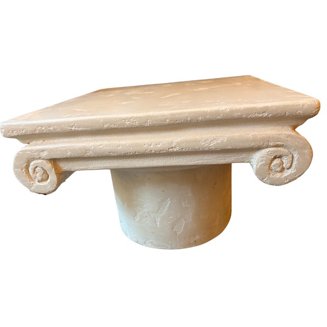 A commanding neoclassical coffee table modeled after the Ionic capital, one of the three classical orders of ancient Greek...