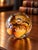 Beautiful vintage Langham Glass paperweight, handcrafted in England, featuring rich amber, golden honey, and warm caramel...