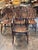 A set of seven English Windsor chairs, each with a hooped back filled with turned spindles about a pierced splat, the side...