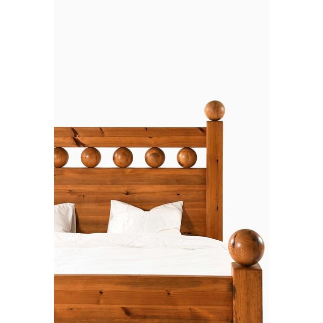 This rare and large double bed, produced in sweden, presents a bold and sculptural interpretation of rustic modernism,...