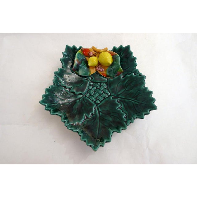 Mid-century earthenware dish with a star-shaped pattern of leaves and a braided center, decorated in relief with lemons...