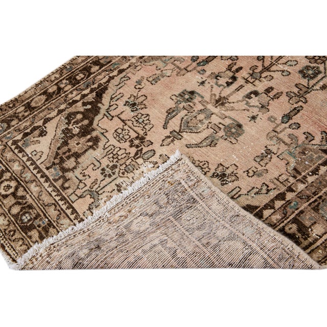 Beautiful Vintage Floral hand-knotted wool runner with a brown field. This runner has brown and tan accents all-over a...