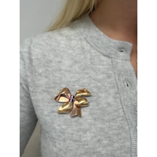 This whimsical retro brooch by Tiffany and Co. in the swirling bow design is tied nicely together with two rows of...