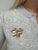 This whimsical retro brooch by Tiffany and Co. in the swirling bow design is tied nicely together with two rows of...