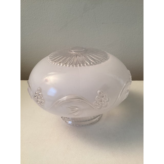 This is a vintage frosted glass ceiling light fixture shade featuring a raised clear glass floral or grape vine pattern....