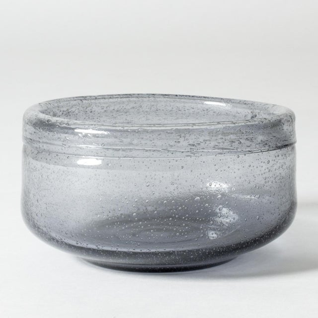 Beautiful, large glass bowl by Erik Höglund, in a cloud grey nuance. Air bubbles encapsulated in the glass create a...