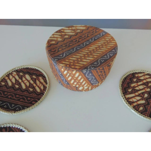 Set of '12' hand woven round batik fabric coasters with original storage box. Yellow and brown textile Printed fabric....