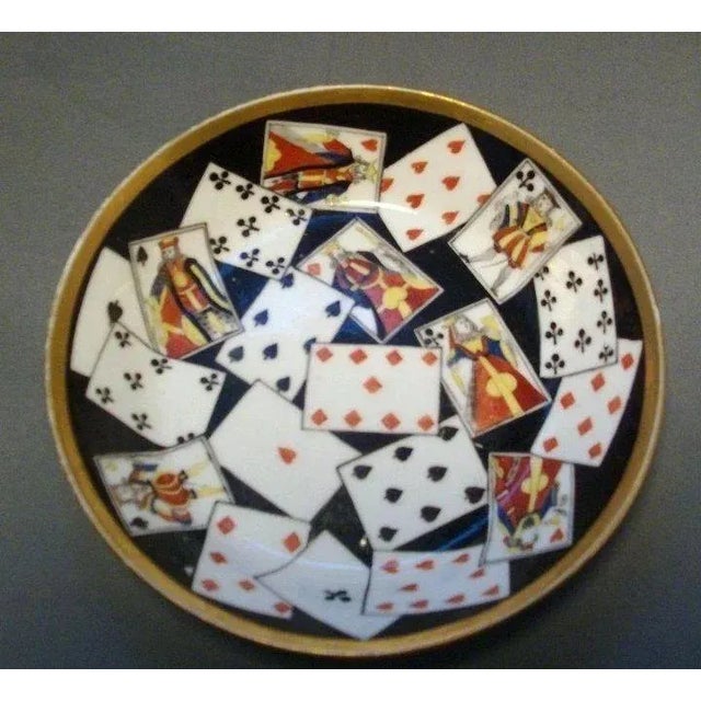 A rare and lovely Paris saucer hand painted with playing cards. Polychrome on black ground and gold. Measures 5 1/8" in...