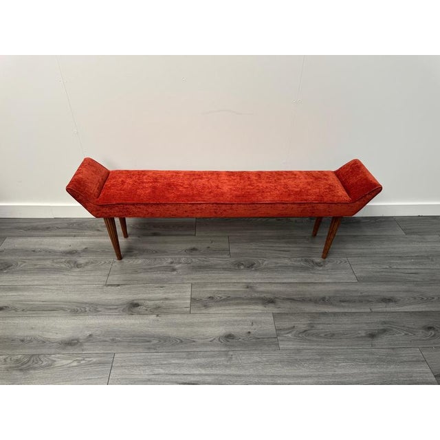 A fine Italian slimline C1950 bench upholstered in finely textured burnt orange Dedar fabric with sleek fluted wooden legs...