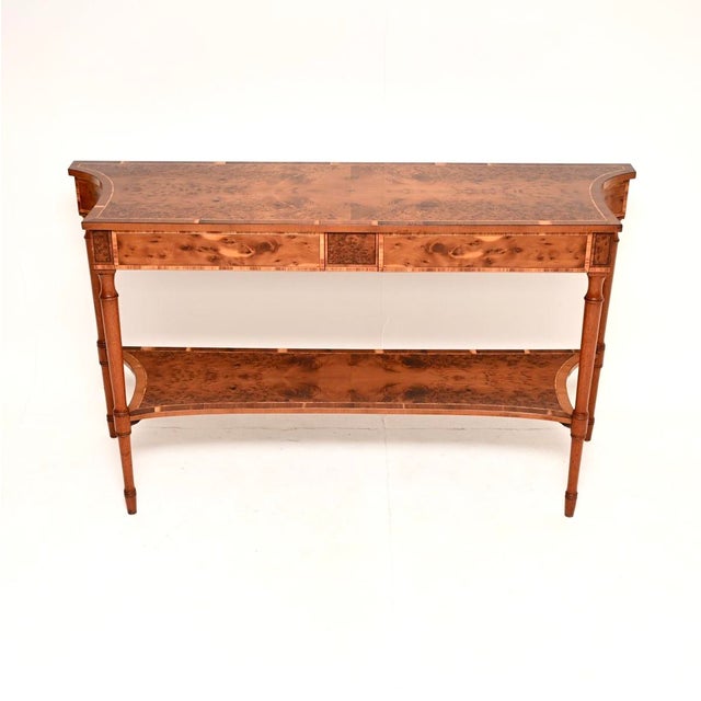 An absolutely beautiful and large antique inlaid yew wood console table. This was made in England in the Sheraton revival...