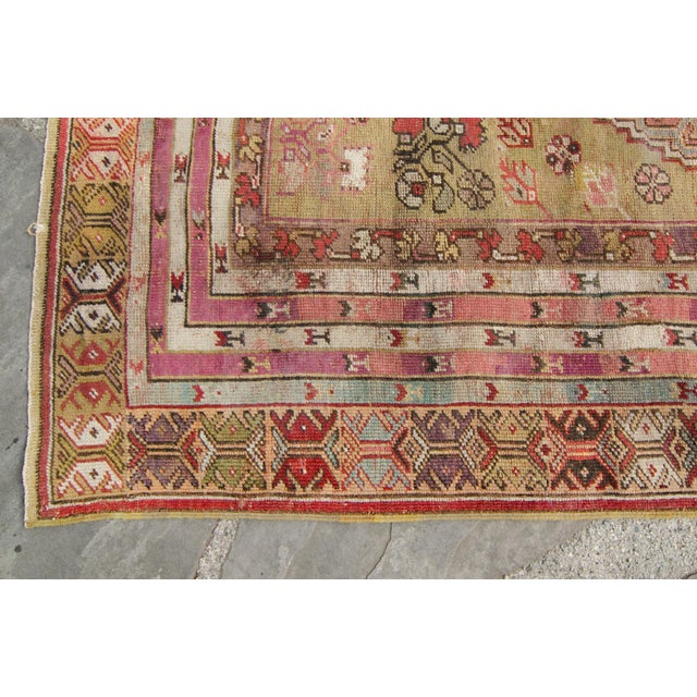 A gracefully aged antique prayer rug with a temple-like motif in the center. A beautiful rug that has maintained its charm...