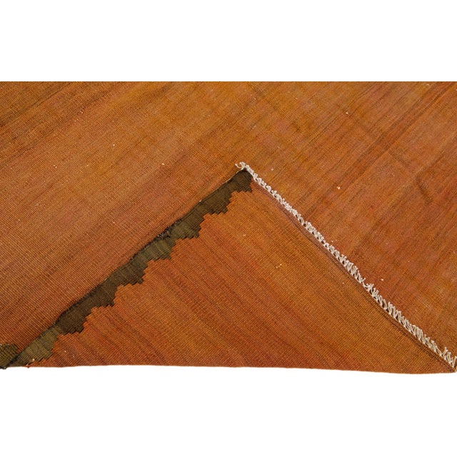 Beautiful vintage Turkish Kilim hand-knotted wool rug with an orange field. This piece has brown accents in an all-over...