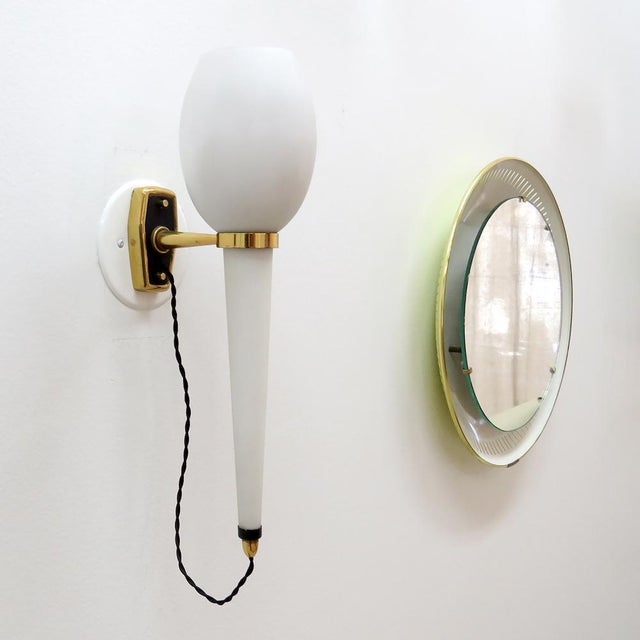 Wonderful Italian wall light by Stilnovo, 1950s, long opaline glass body suspended from brass and black enameled hardware,...