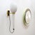 Wonderful Italian wall light by Stilnovo, 1950s, long opaline glass body suspended from brass and black enameled hardware,...