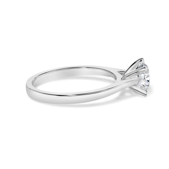 Immerse yourself in the refined elegance of this exquisite engagement ring, where contemporary design meets classic...